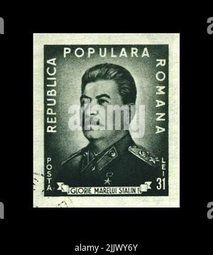 Joseph Stalin, famous soviet politician leader, 70th birth anniversary, circa 1949. The Soviet Army memorial. Vintage postal stamp of Romania isolated Stock Photo