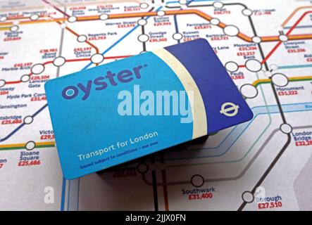 Contact, less, contactless credit cards and London Underground Oyster card and tube map with average annual income salary Stock Photo