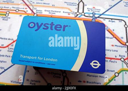 Contact, less, contactless credit cards and London Underground Oyster card and tube map with average annual income salary Stock Photo