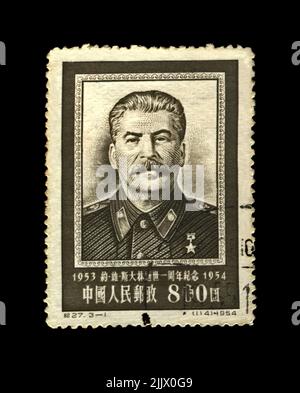 Joseph Stalin, famous soviet politician leader, 1st anniversary of the death, circa 1954. Vintage stamp of China isolated on black background. Stock Photo
