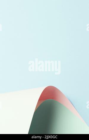 Abstract wave of pastel green and pink paper on light blue background. Creative geometric curved paper with light and shadows. Abstract geometry Stock Photo