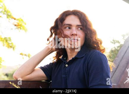 Young Woman looking away while standing in city Stock Photo