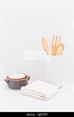 kitchenware and earthenware on a white desk against white wall Stock Photo
