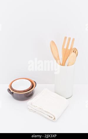 kitchenware and earthenware on a white desk against white wall Stock Photo