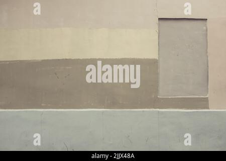 Concrete wall of building painted with stripes of various shades of beige color on street Stock Photo