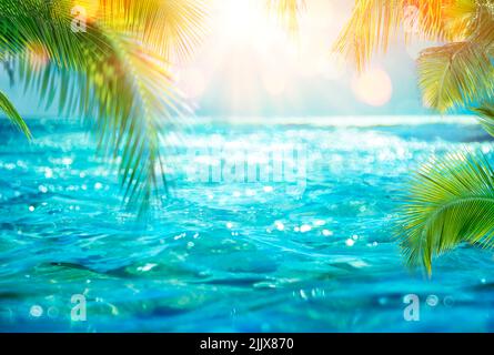 Abstract Summer - Blurred Sea With Leaves Palm And Defocused Bokeh Lights On Ocean Stock Photo