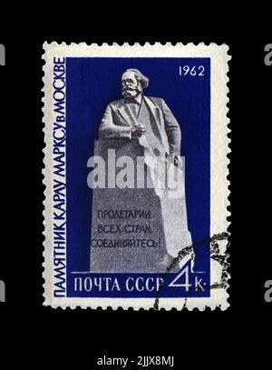 Karl Marx monument in Moscow, famous politician leader, Capital book author, circa 1962. canceled postal stamp printed in the USSR isolated on black Stock Photo