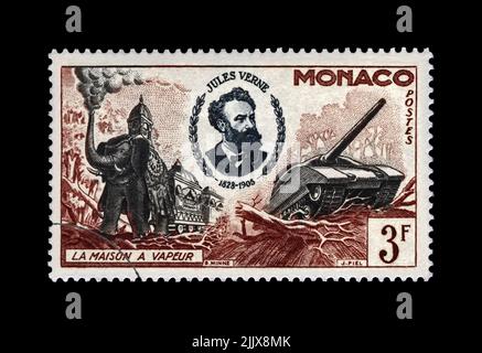 Jules Verne (1828-1905), famous science writer and steam house, military machines, circa 1955. canceled postal stamp printed in Monaco isolated Stock Photo