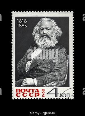 Karl Marx, famous politician leader, Capital book author, circa 1968. canceled postal stamp printed in the USSR isolated on black background. Stock Photo