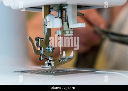 Sewing machine parts close-up - foot and needle. Selective focus Stock Photo