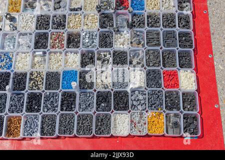 Assortment of Plastic and Rubber Spare Parts in Trays for Cars Stock Photo