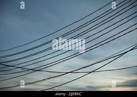 Electrical wires on pole. Many wires against sky. High voltage pole. Stock Photo