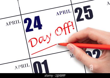 24th day of April. Hand writing text DAY OFF and drawing a line on calendar date 24 April. Vacation planning concept. Spring month, day of the year co Stock Photo