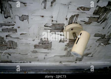 Spotlight hanging on rustic wooden ceiling Stock Photo