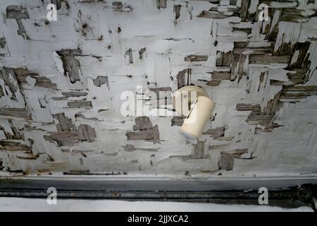 Spotlight hanging on rustic wooden ceiling Stock Photo