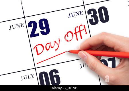 29th day of June. Hand writing text DAY OFF and drawing a line on calendar date 29 June. Vacation planning concept. Summer month, day of the year conc Stock Photo