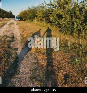 Two people holding hands as they are leaving a park in Gardner Kansas Stock Photo