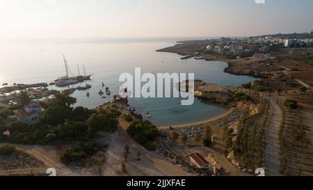 Aerial bird's eye view of Green bay in Protaras, Paralimni, Famagusta, Cyprus. The famous tourist attraction diving location rocky beach with boats, s Stock Photo