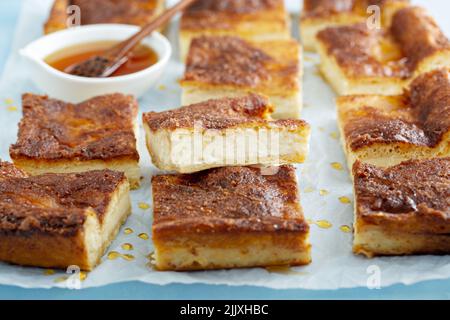 Cinnamon honey cheesecake pie cit into squares Stock Photo