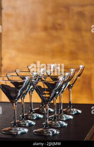 eight martini glasses lined up in rows Stock Photo