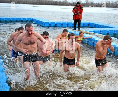 Epiphany near Svjato-Pokrovskiy Cathedral in Kiev,Ukraine. People plunging into ice-cold water as it helps body became resilient to illness. Stock Photo
