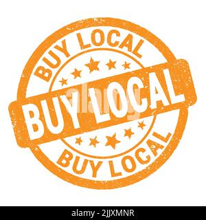 BUY LOCAL text written on orange grungy stamp sign. Stock Photo