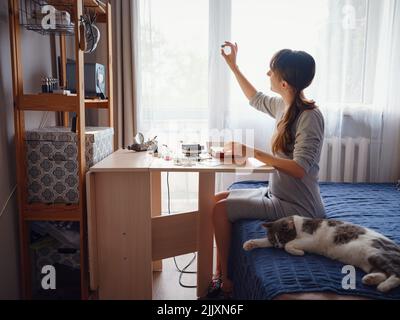 Lifestyle concept, work from home to reinvent your life - Jewelry designer workplace. Woman make jewelry. Georgian minankari enamel manufacturing tech Stock Photo