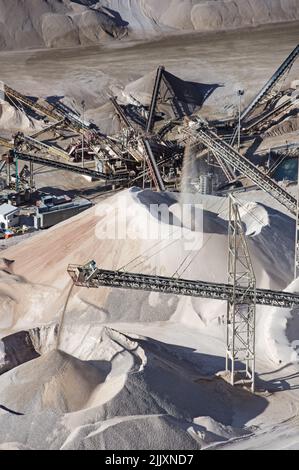 aggregate mine piles viewed from above with conveyor belts dumping gravel Stock Photo