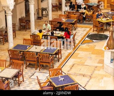 Dubai, UAE - 07.16.2022 - Families having lunch in of the cafes of Wafi shopping mall Stock Photo