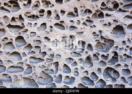 natural pocketed volcanic tuff rock background texture Stock Photo