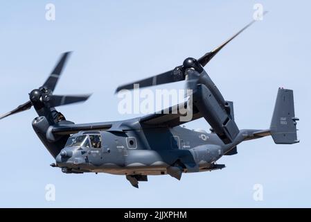 US Air Force CV-22B Osprey tilt-rotor flying at the Royal International Air Tattoo airshow at RAF Fairford, UK. Rotors in transitional position Stock Photo