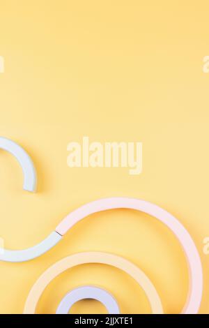 Abstract geometric figures composition. Wooden geometrical shapes and lines on pastel yellow background. Top view Stock Photo