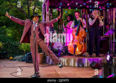 London, UK. 28th July, 2022. Kalungi Ssebandeke, Feste, with the band - Theatre on Kew preview of Twelfth Night along Pagoda Vista in front of the Great Pagodaw in Kew Gardens. Set in the 1930's the show runs 29 July to 29 August 2022. Credit: Guy Bell/Alamy Live News Stock Photo