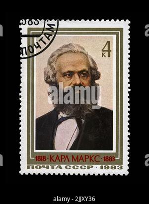 Karl Marx, famous politician leader, Capital book author, circa 1983. Vintage canceled postal stamp of the USSR isolated on black background. Stock Photo