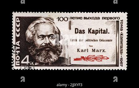 Karl Marx, famous politician leader, Capital book author, circa 1967. Vintage canceled postal stamp printed in the USSR isolated on black background Stock Photo