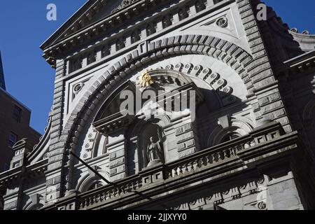 New York, NY, USA - July 27, 2022: The stone architecture above the entrance to St Francis Xavier Church on W 16th St in Manhattan Stock Photo