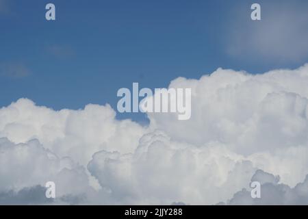Blue sky background with fluffy clouds Stock Photo