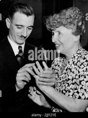 Helen Keller Visits Industrial Blind Institute - Helen Keller talking to Norman Wilkinson during her visit the Industrial Blind Institute this afternoon, Wilkinson who is blind and deaf through war injuries he received while fighting in New Guinea works as a potter at the Institute. April 7, 1948. (Photo by Ernest Charles Bowen/Fairfax Media). Stock Photo