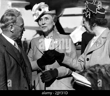 Arrived by ANA Skymaster from America - Miss Helen Keller the famous American deaf & blind authoress one of the greatest women living today arrived to begin an extensive tour of Australia. Here in the centre she is greeted by Mr Justice Maxwell (Pres of Sydney Industrial Blind Institution who is on the left. His words of welcome are conveyed to Miss Keller by her companion Miss Polly Thompson (right) by means of the hands. March 29, 1948. (Photo by Frederick John Halmarick/Fairfax Media). Stock Photo