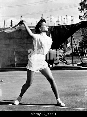 .. Katharine Hepburn is the tennis ace who plays a love of a game in M-G-M's 'Pat and Mike' in which she co-stars with Spencer Tracy. As the all-round athlete, she's managed by Tracy, a tough sports manager with whom she gets embroiled romantically and professionally. Also heading the all-star cast are Aldo Ray, William Ching and such sports stars as Babe Didrikson Zaharias, Gussie Moran, Frank Parker, Don Budge, Alice Marble, Helen Dettweiler, Beverly Hanson, and Betty Hicks. Directed by George Cukor. Produced by Lawrence Weingarten. Written by Ruth Gordon and Garson Kanin. September 1, 1952. Stock Photo