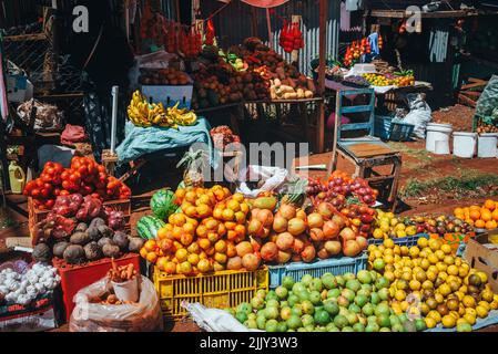 Fruit and vegetable market in Africa. Colorful healthy ingredients from the farm or from nature at the local market in Kenya. Bananas, mangoes, fruits Stock Photo