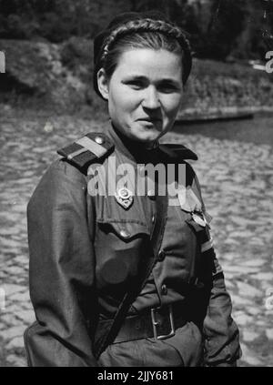 Red Army Woman Soldier Guards The Allied Front on The Elbe -- Karuma Galemua, a young Soviet police woman from Astrakhan, on guard over the pontoon bridge at Torgau-on-the-Elbe, where the Americans joined up with the Red Army, cutting Germany in two. Karuma fought in many battles, including Stalingrad, and has killed 42 Germans. May 5, 1945. (Photo by Planet News Ltd.). Stock Photo