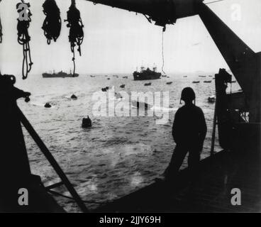 From one the invasion Armada craft a marine watches landing craft