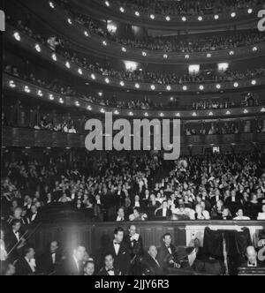 Met Starts Its 1947 Season -- This photo of the opening night crowd at the Metropolitan Opera House, New York City, Nov. 10, was made during the first intermission between acts of Verdi's Un Ballo in Maschera. The famed Diamond Horseshoe is first tier of boxes above the orchestra level. October 11, 1947. (Photo by Associated Press Photo). Stock Photo