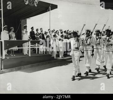 Salute Duke of Edinburgh salutes a march-past of naval ratings at Balmoral Naval Depot today. The Queen looks calm as she views the parade. February 18, 1954. Stock Photo