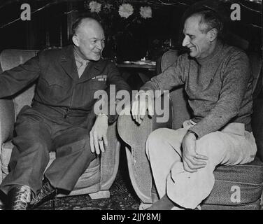 General Dwight D. Eisenhower (left), Allied Supreme Commander conferring with Field-Marshal Sir Bernard Montgomery. C.-in-C., British Forces, at the later's headquarters in Belgium recently. Field-Marshal Montgomery is wearing the sweater and informal dress he usually appears in while on active service. General Eisenhower and General Montgomery photographed at a conference at Headquarters in France during the war. December 30, 1944. (Photo by 'U.S: Office Of War Information Picture'). Stock Photo