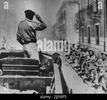 Montgomery Salutes Invasion Troops - Gen. Sir Bernard L. Montgomery, chief of the British Eighth Army, salutes his troops as they file through a street in Reggio Calabria, Italy. September 7, 1943. (Photo by AP Wirephoto). Stock Photo