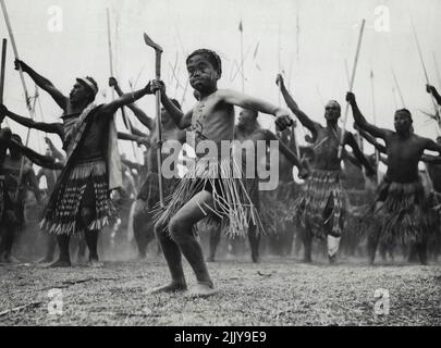 A young Maori leads warriors in a war dance. February 20, 1934. (Photo by The Auckland Weekend News). Stock Photo