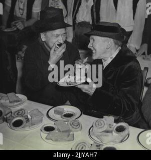 A spot of gossip, a nice cuppa tea and a bit of cake was a day not to be for forgotten by these two elderly pensioners who had the time of their lives. Gifts of a shilling each meant much to them. May 06, 1944. Stock Photo