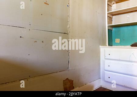 Damaged wall being repaired with sheetrock Stock Photo